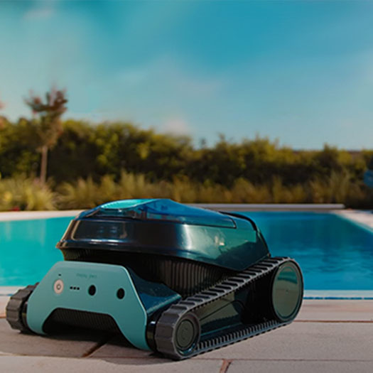 Dolphin Liberty cordless robot on the deck beside a backyard pool