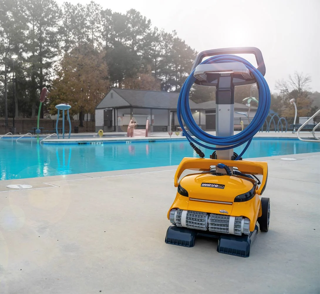 Dolphin Wave 60 on its caddy beside a community pool